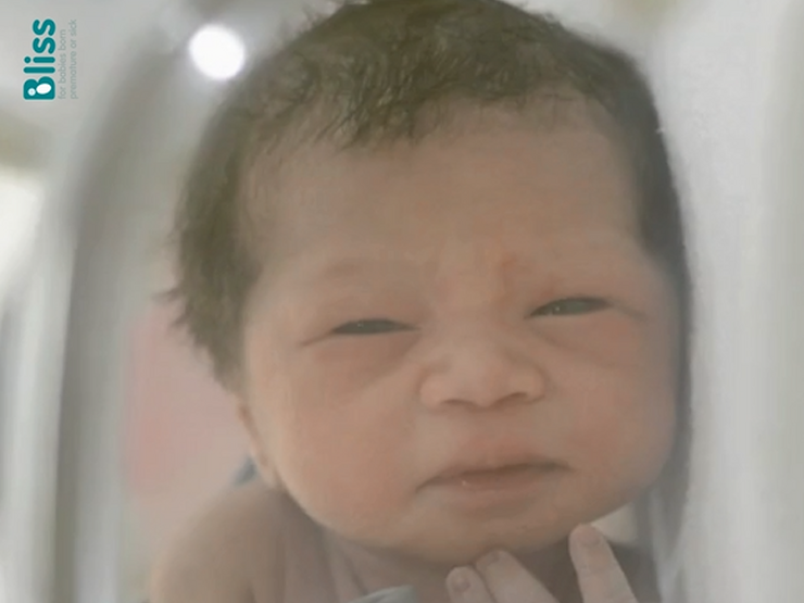 Close up on baby's face - baby has dark hair and features in the video on this webpage