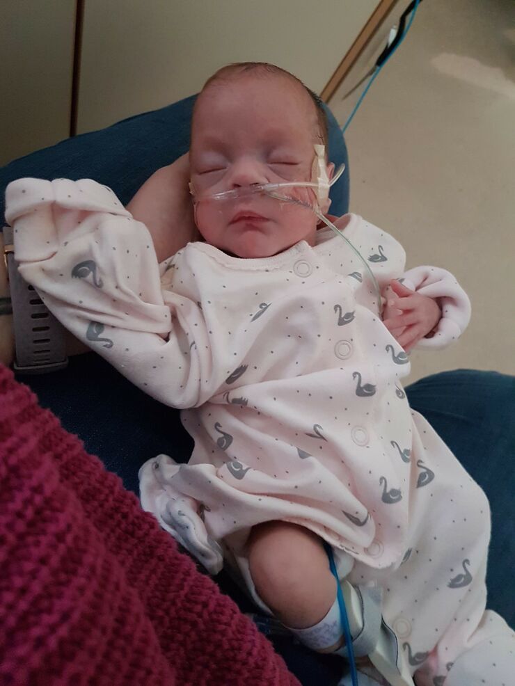 Elizabeth, a baby being held on lap in hospital