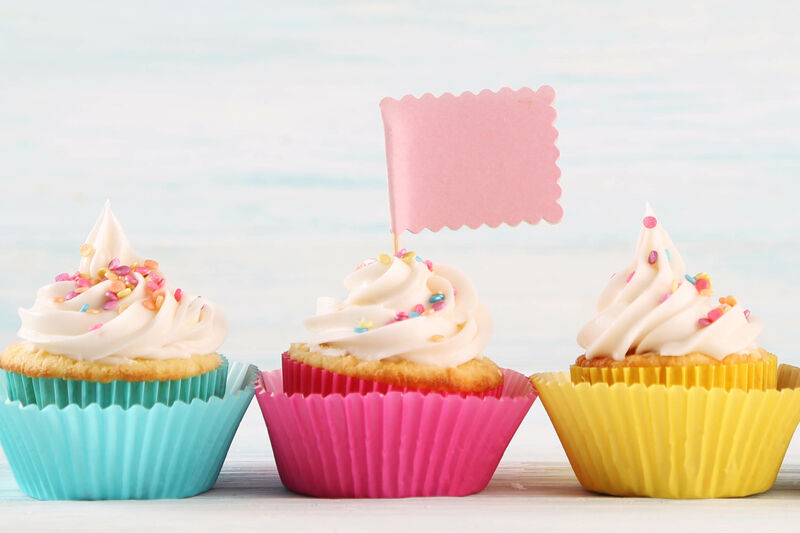 3 cupcakes lined in a row, the middle one has a flag in it