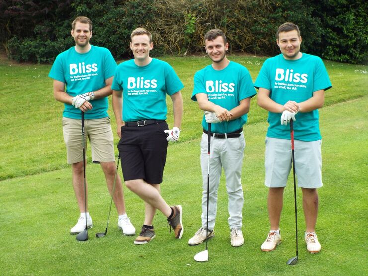 four men posing with Golf clubs wearing Bliss t-shirts