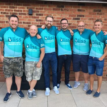 Group of riders standing in their jerseys