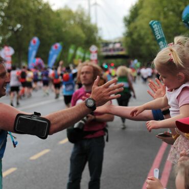 Bliss runner highfiving someone in the crowd