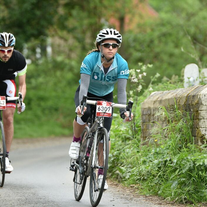 Two Bliss riders cycling on country lane