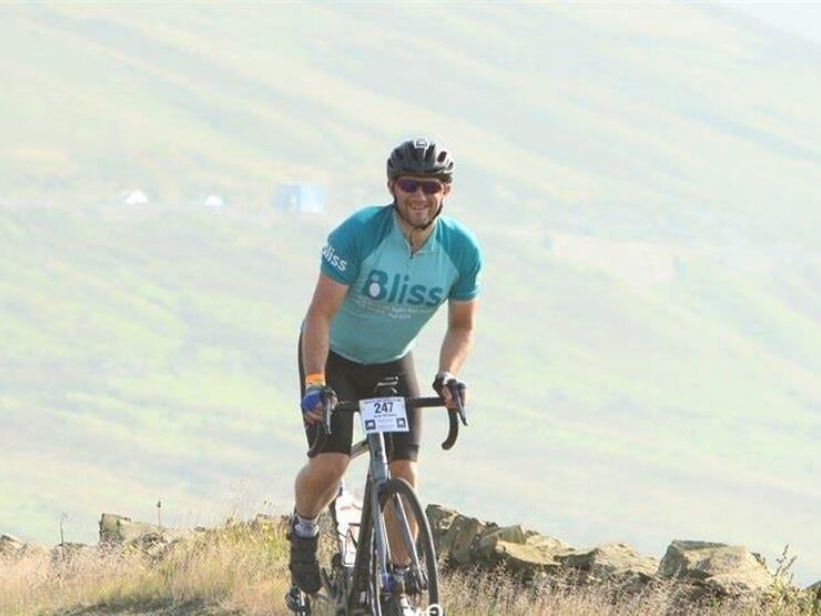 Bliss cyclist cycling up hill