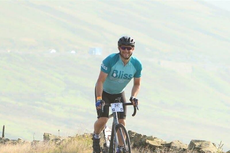Bliss cyclist cycling up hill