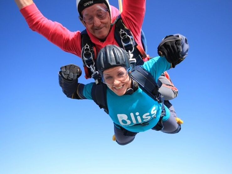 Bliss female fundraiser mid-air during a tandem skydive