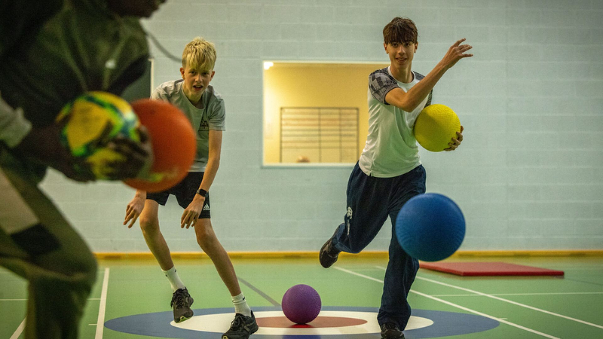 Smiling children playing dodgeball
