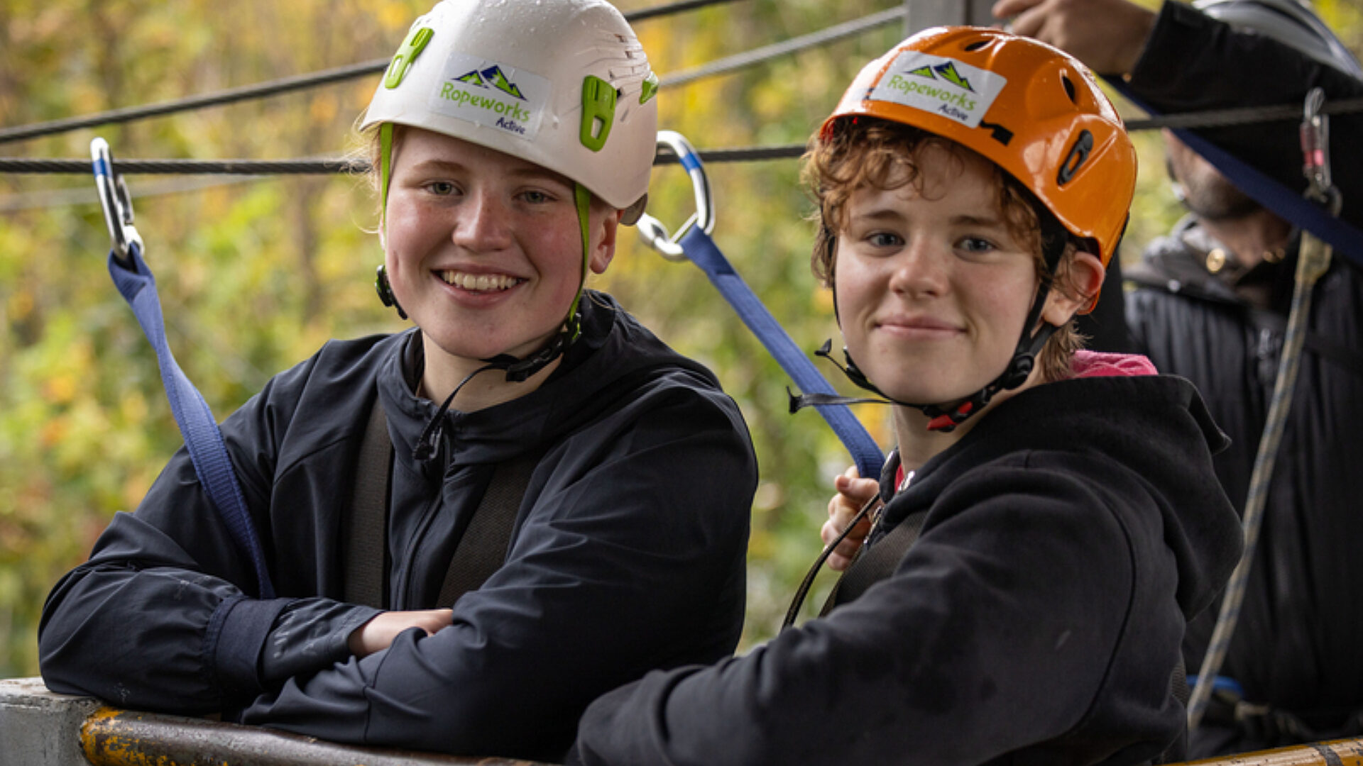Smiling friends taking a break from adventurous training