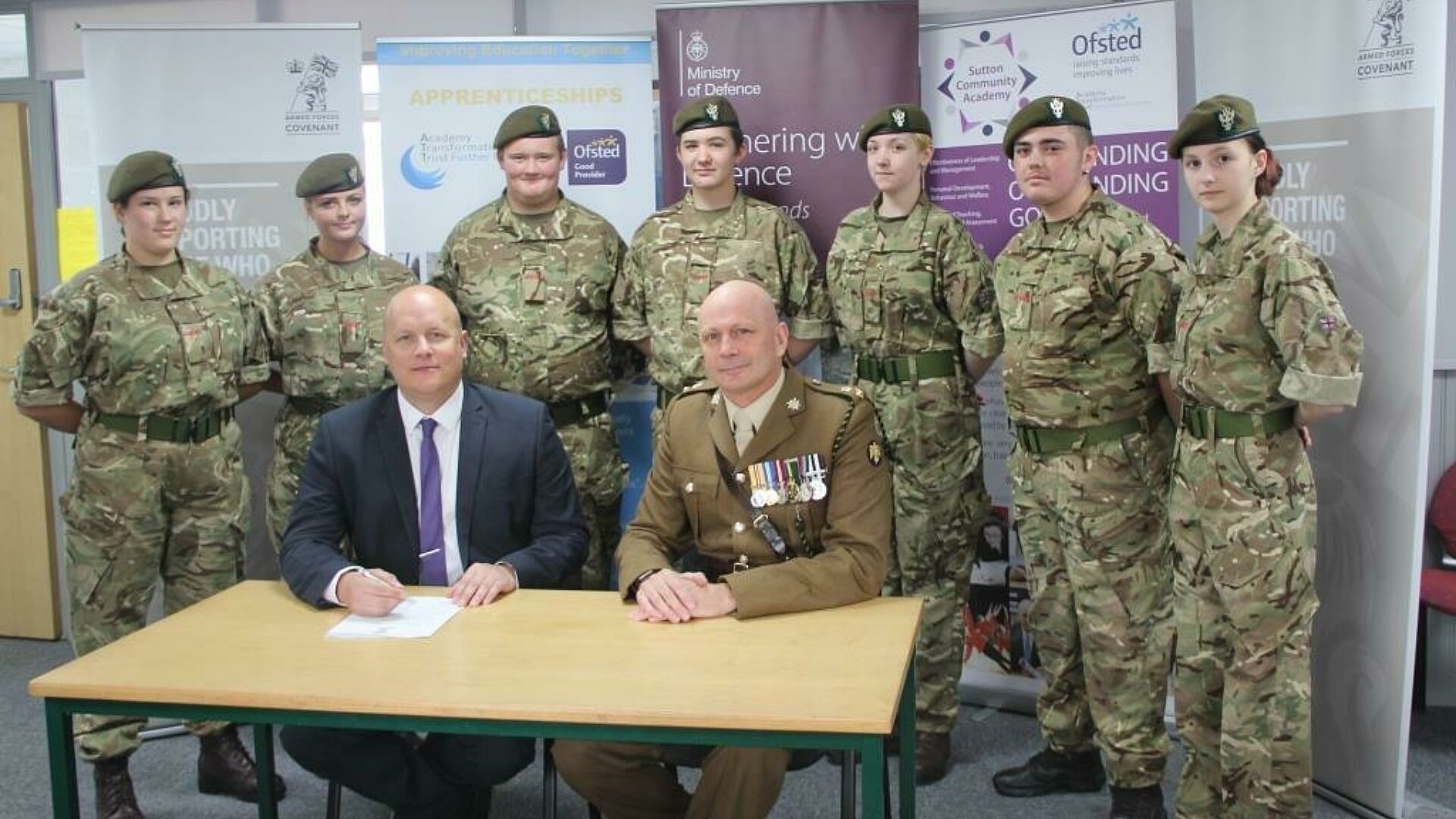 Principal Tim Croft and Lt Col Keith Spiers with cadets from the schools cadet unit 1