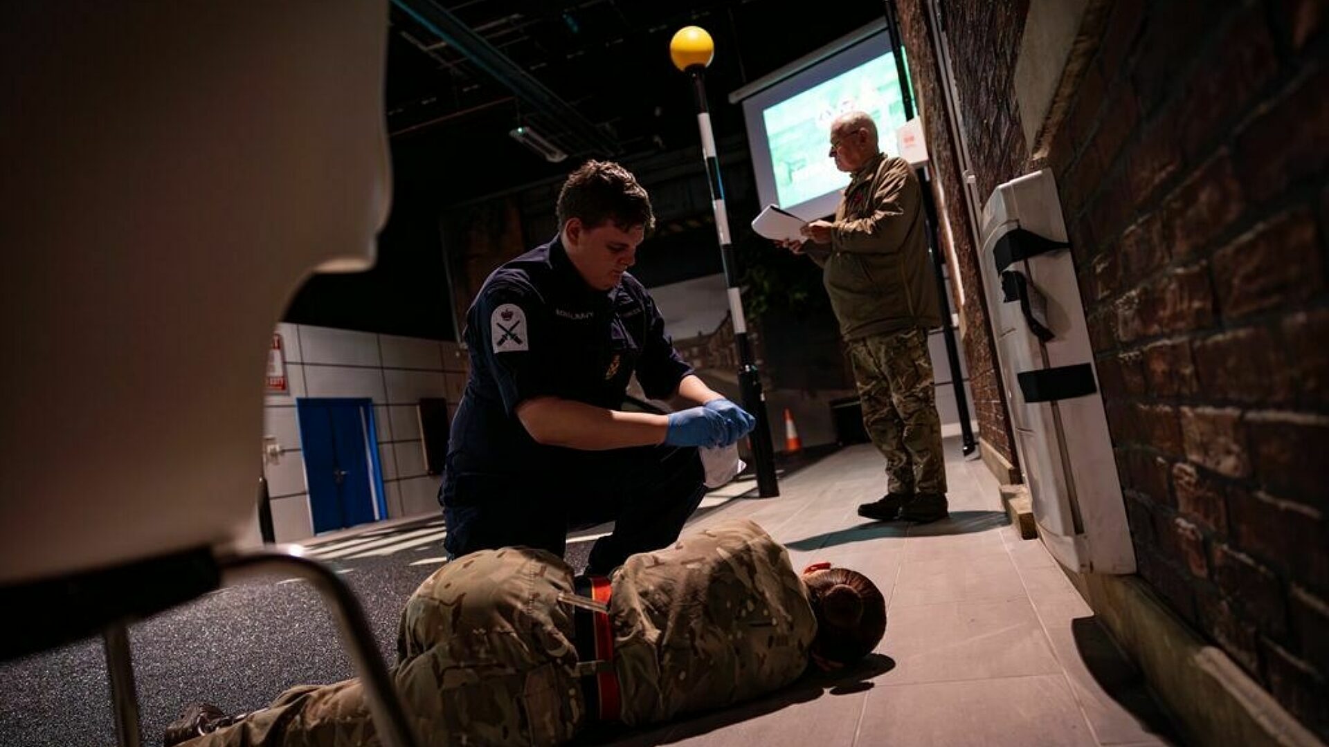 CFAV runs through a first aid scenario on a dimly lit stage