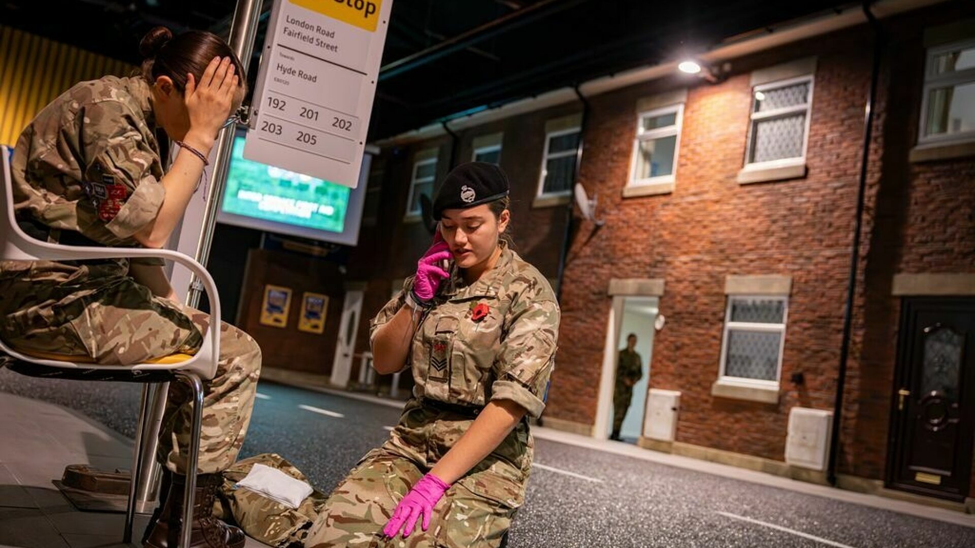 Competing cadets running through a first aid scenario on a staged street
