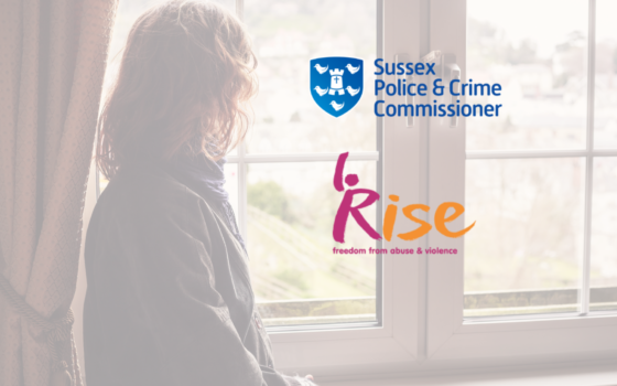 Photograph of a young person looking out through a white double glazed window with a curtain behind them, from the back. Logos for rise and the Sussex Place in crime commission overlay.