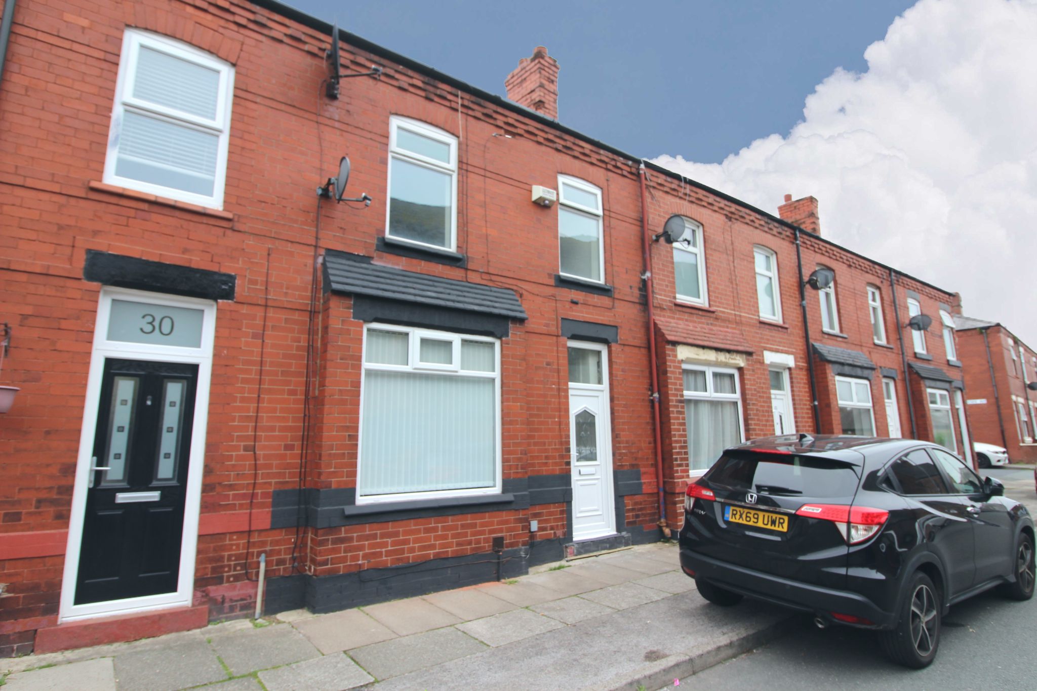 3 bedroom mid terraced house To Let in Wigan - Photograph 1.