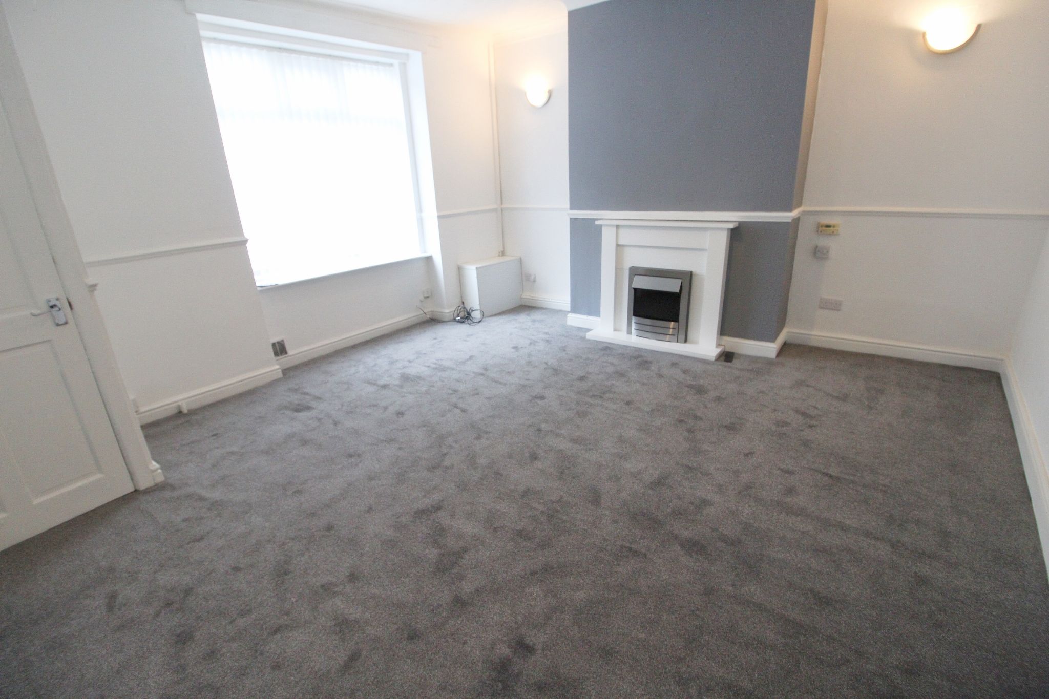 3 bedroom mid terraced house To Let in Wigan - Photograph 1.