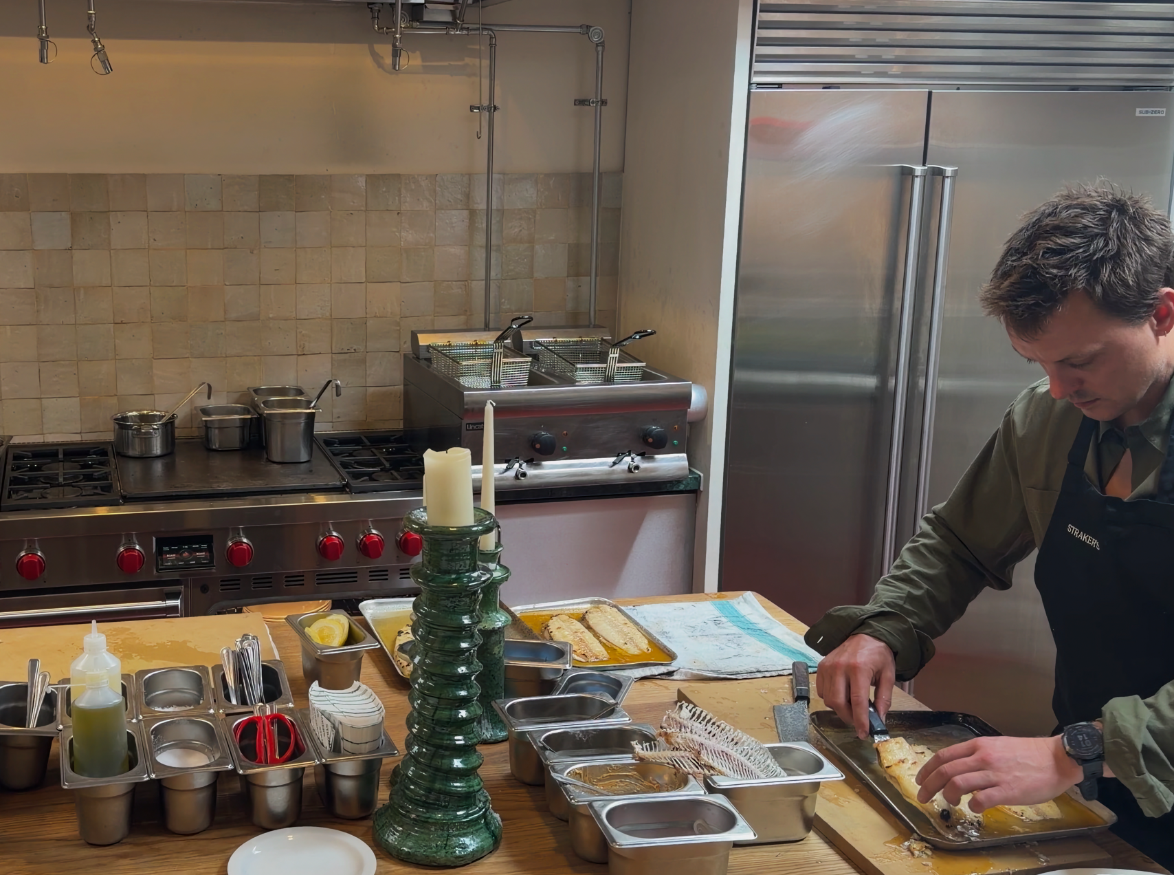 The chef's-table kitchen featuring Sub-Zero & Wolf appliances