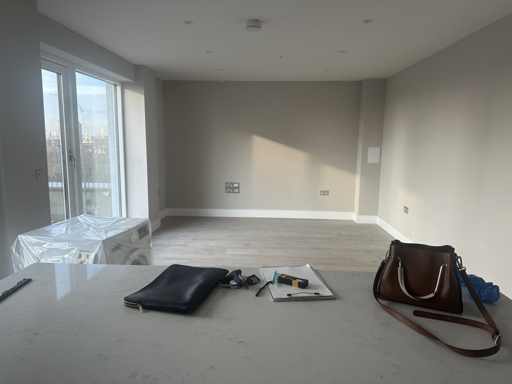 Vacant openplan living room kitchen photographed before staging and furniture rental