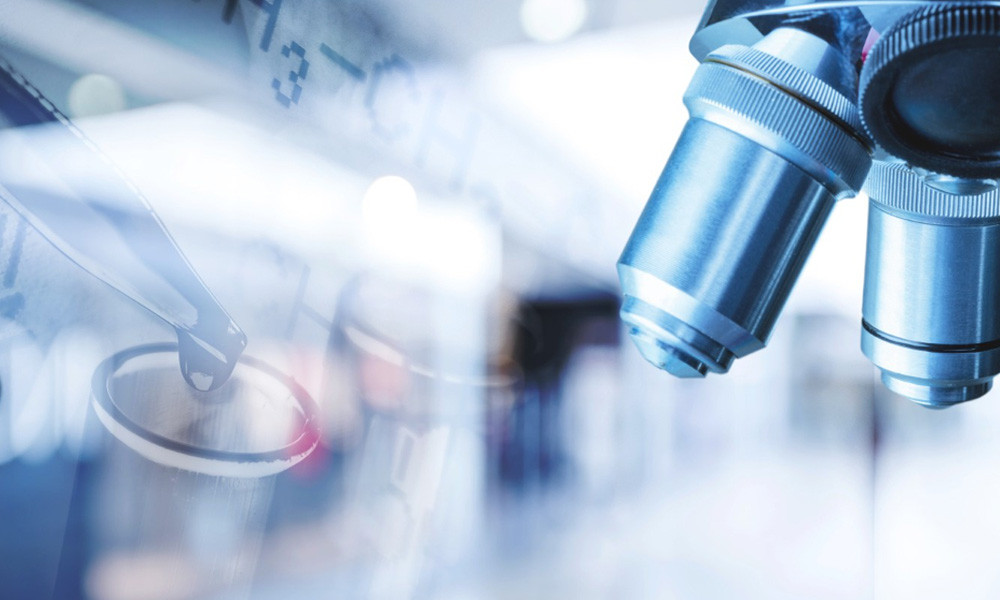 Close up of laboratory pipette and microscope used for scientific research | Amodaia