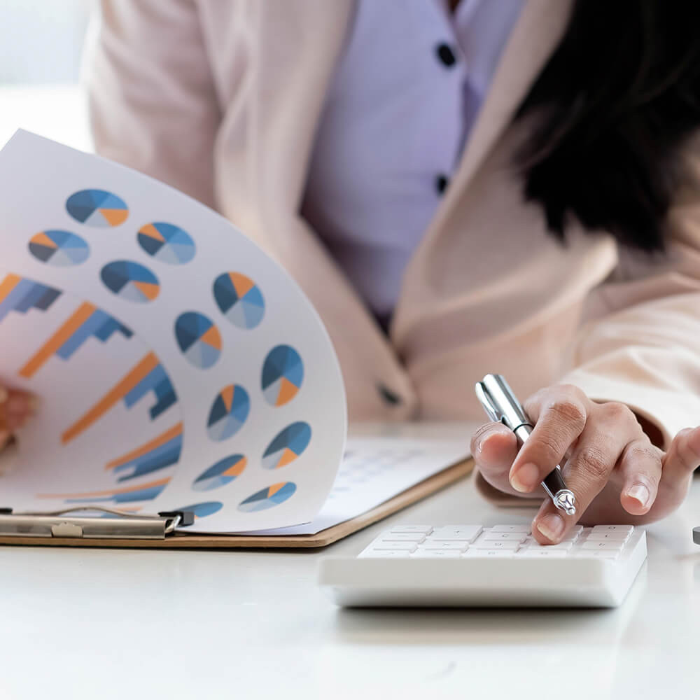 close-up-business-woman-using-calculator-and-lapto-2023-11-27-05-19-39-utc.jpg.jpeg