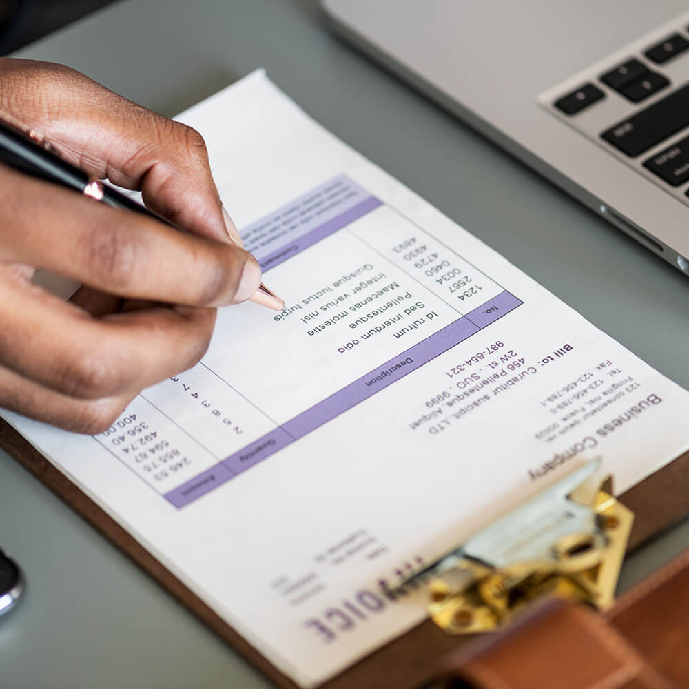 closeup-of-business-man-checking-tax-invoice-paper-2023-11-27-04-49-34-utc.jpg
