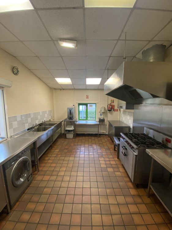Professional community kitchen with stainless steel surfaces, large oven and cooker, ideal for catering and event preparation | Catherine Beckett Community Centre