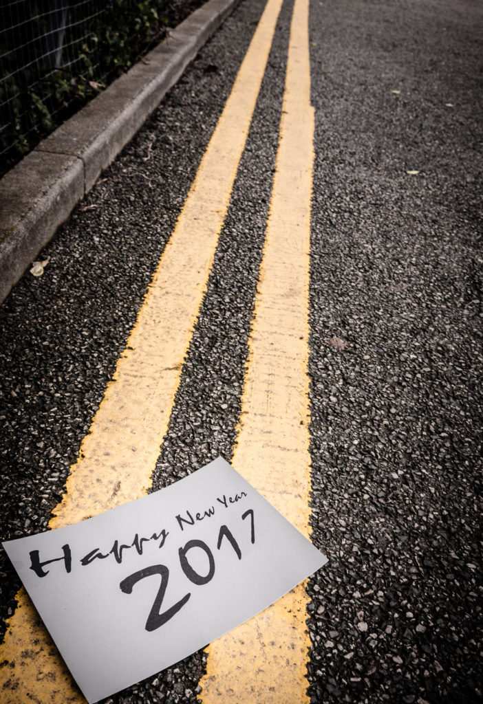 Happy New Year sign on a set of double yellow lines