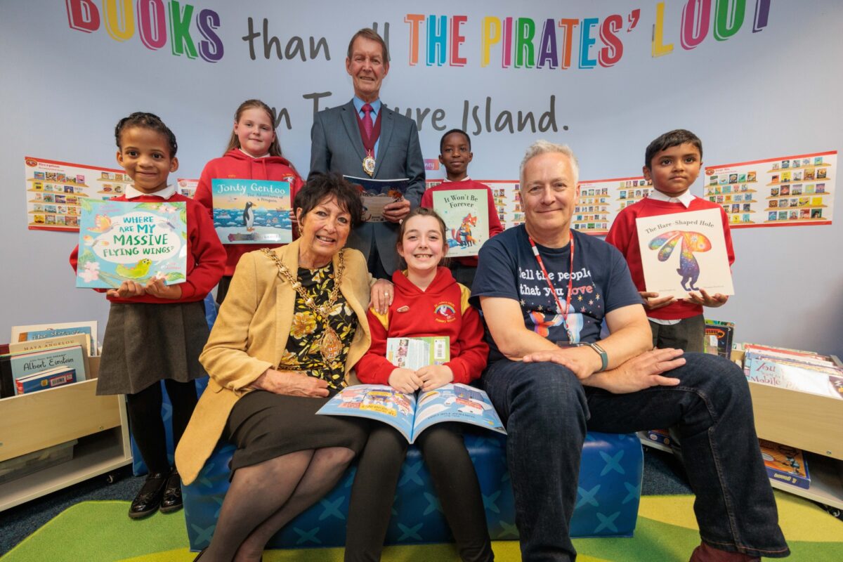 Children sat with Stoke's mayor and a childrens author, as part of Bookmark's roots to reading programme.