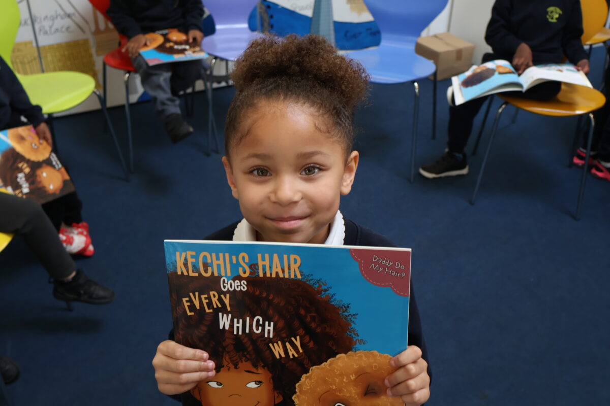 Child holding Kechi’s Hair Goes Every Which Way at Pakeman Primary School during a storytelling session with author Tola Okogwu.