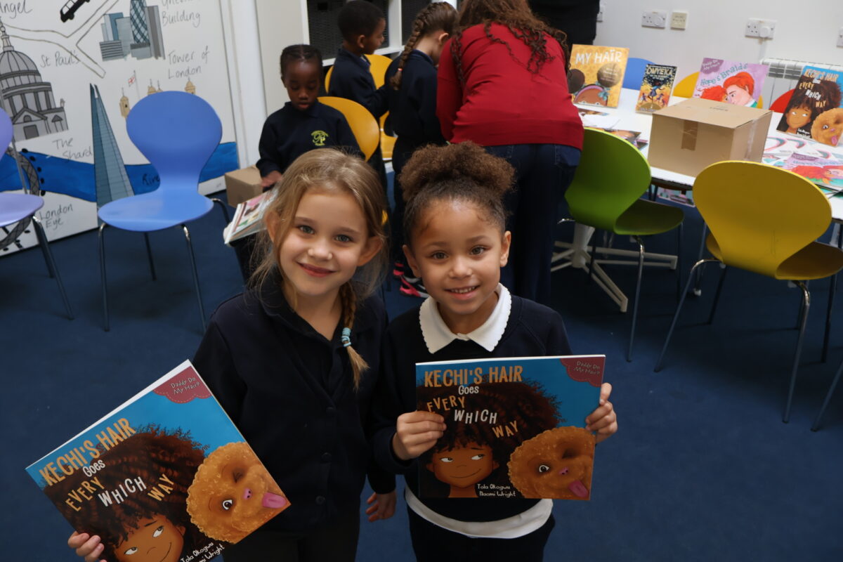 Children holding signed copies of Kechi’s Hair Goes Every Which Way gifted by Tola Okogwu.