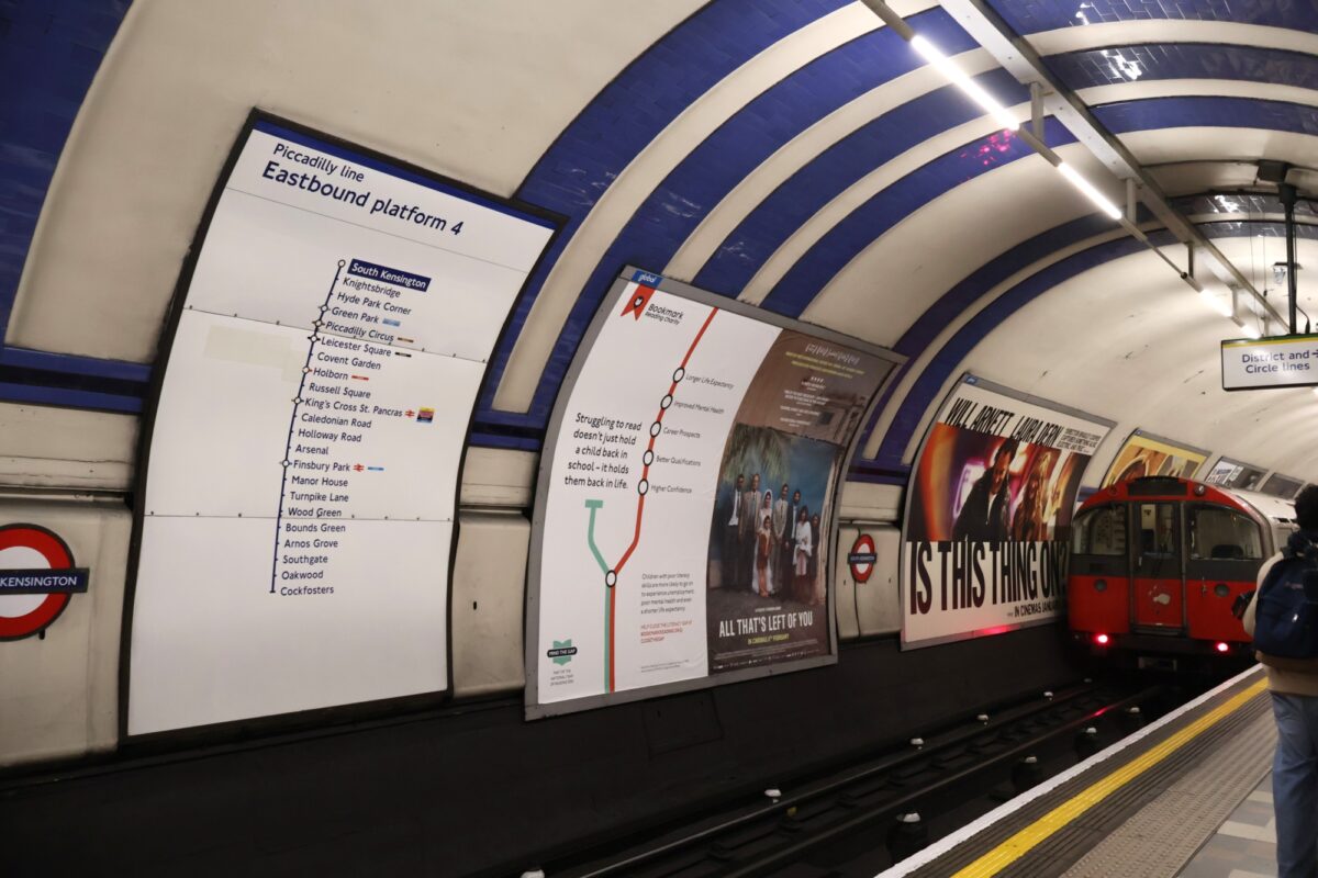 Mind the Gap poster at London Underground tube station highlighting literacy gap campaign in UK