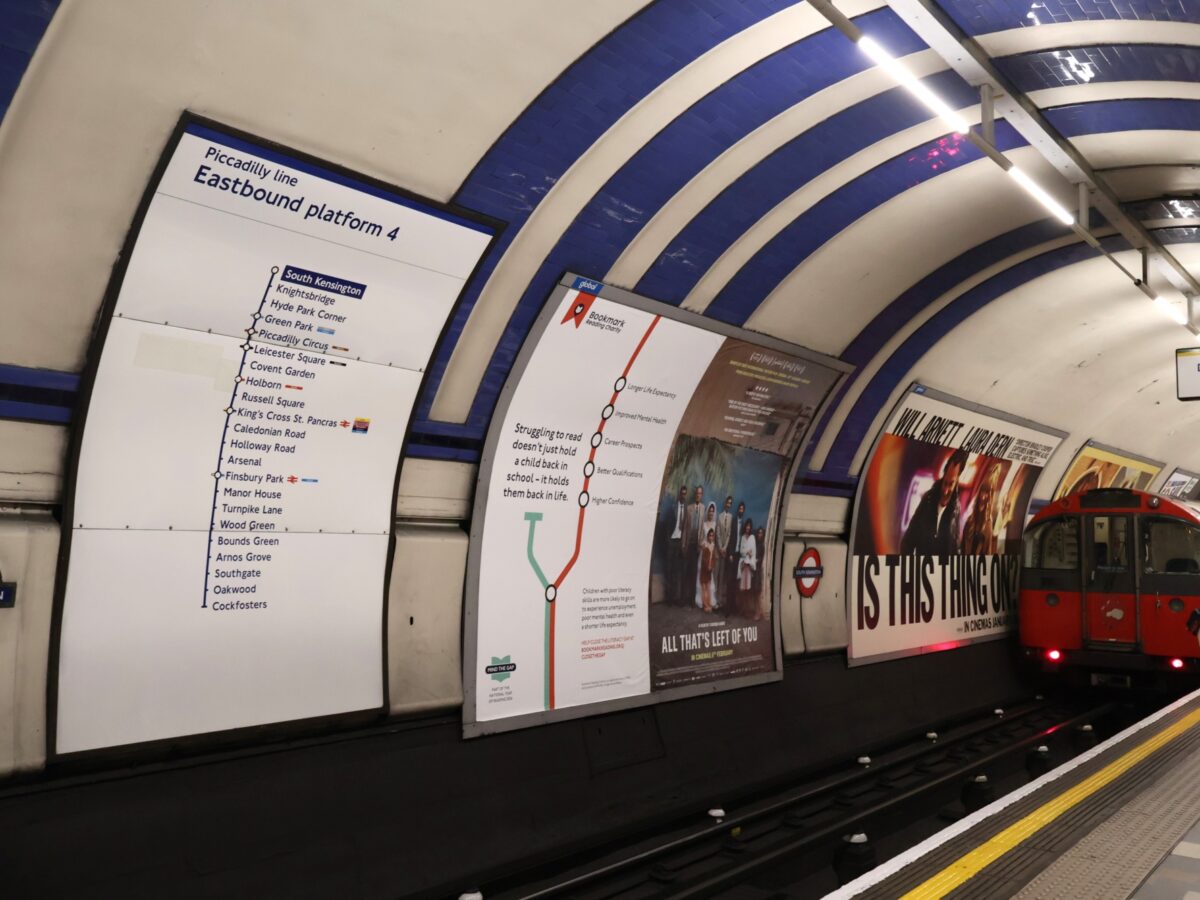 Mind the Gap poster at London Underground tube station highlighting literacy gap campaign in UK