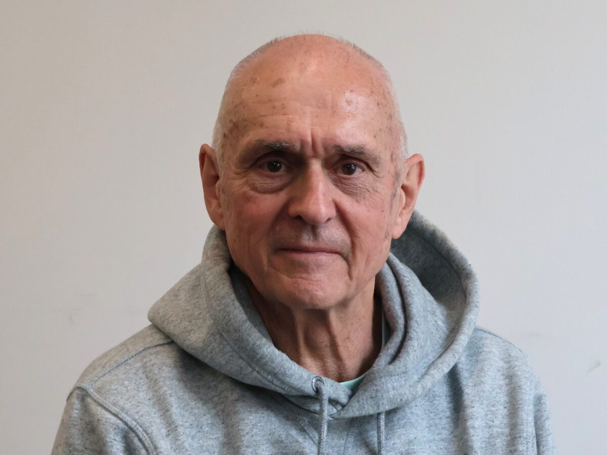 Bookmark trustee wearing a grey jumper and looking at the camera
