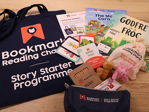 a flat lay of contents of 2026 story starter pack, including books, stationery and activity sheets