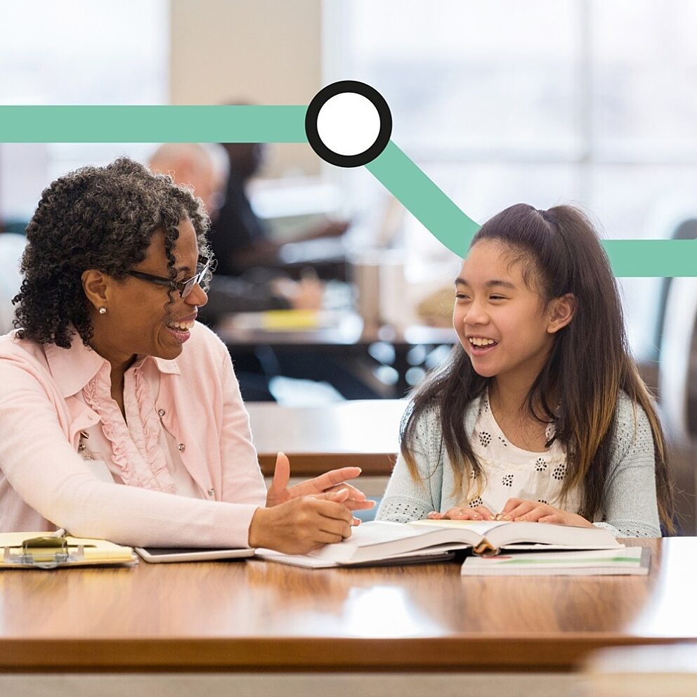 Bookmark volunteer sitting at a table with a young reader, both looking at an open book, with a teal campaign graphic overlay for the Mind the Gap initiative during the National Year of Reading