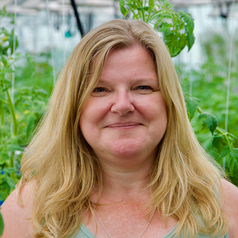 A photo of one of our staff in the greenhouse