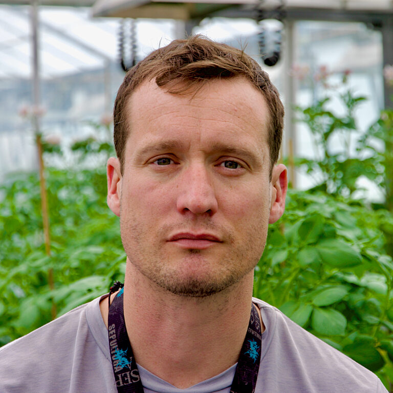 A photo of one of our staff in the greenhouse