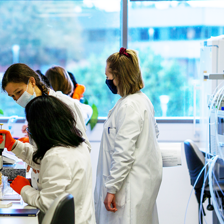 Photograph showing scientists being trained in a laboratory