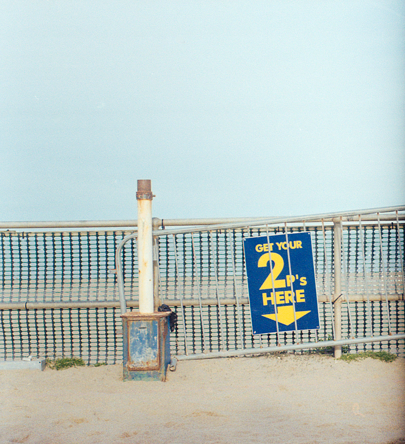 Image of a 2p sign on a beach