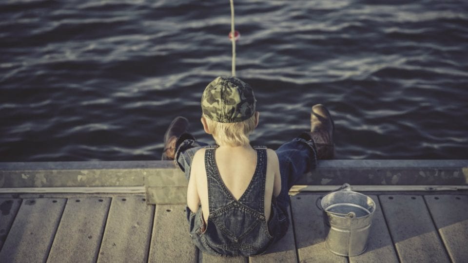 Kid Fishing to make metaphor in fishing for leads