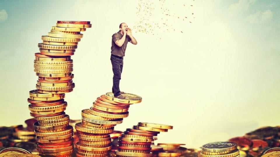 man standing on a pile of money