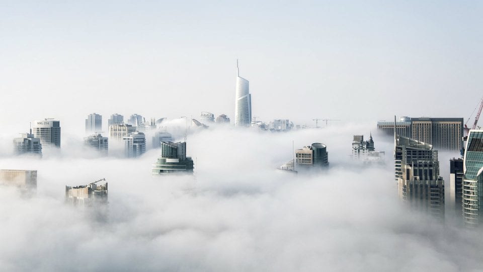 skyscrapers through clouds