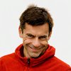 Profile image of Prof. Ben Gibbison smiling and wearing a red jacket