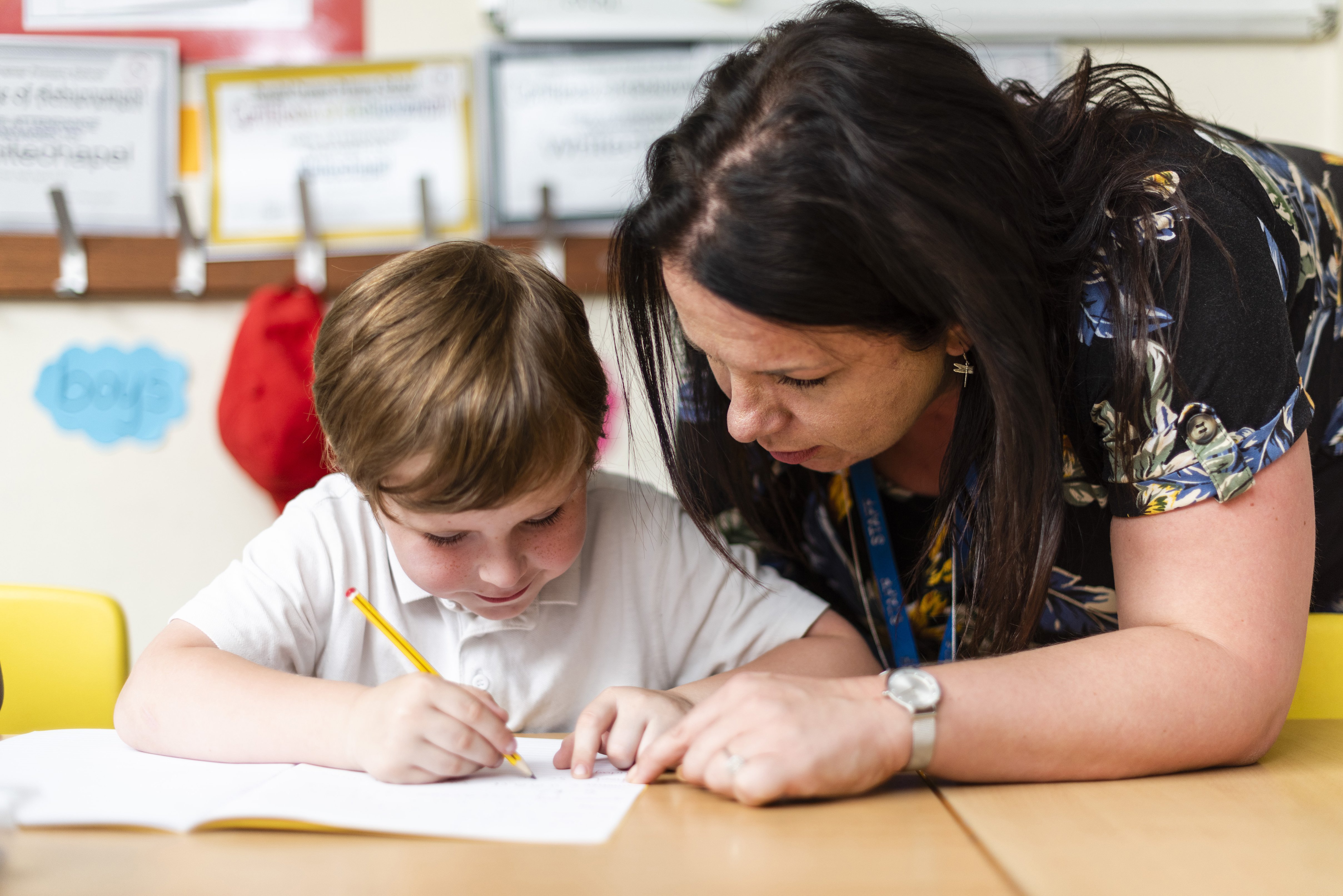 Randal Cremer_child at desk studying with teacher1